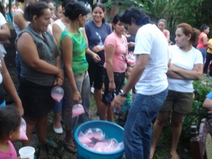Bags of juice are distributed among these Purísima worshippers
