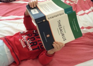 'Soaking up English like a sponge:' The researcher's young son engrossed in a Thesaurus