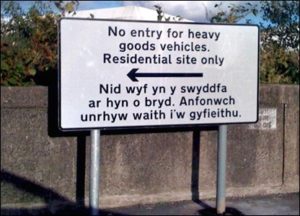 The Welsh message on this road sign translates as "I am not in the office at the moment. Send any work to be translated."